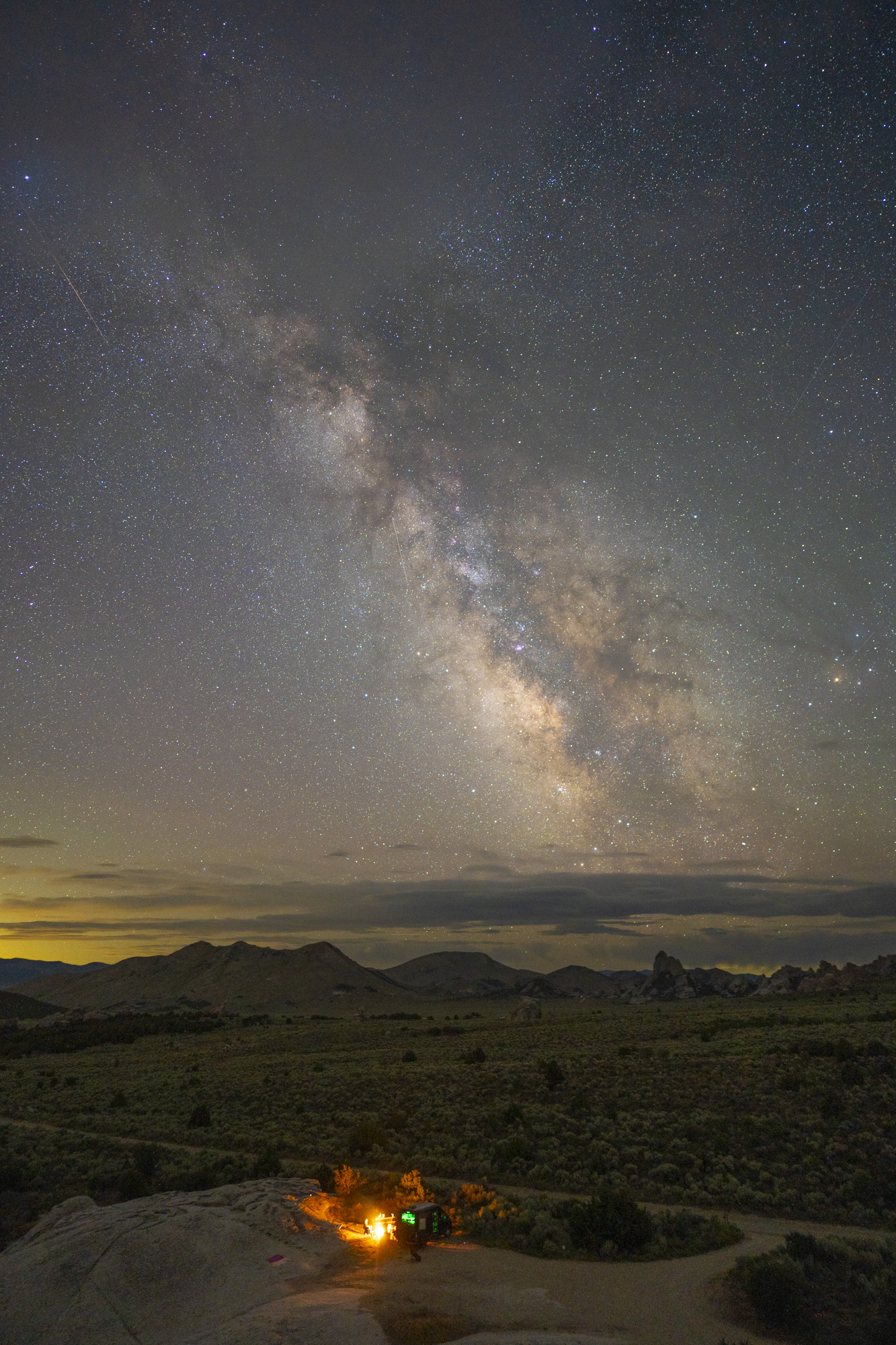 A wide landscape photo of the Milky Way and Rho Ophiuchi cloud complex from City of Rocks, Idaho.